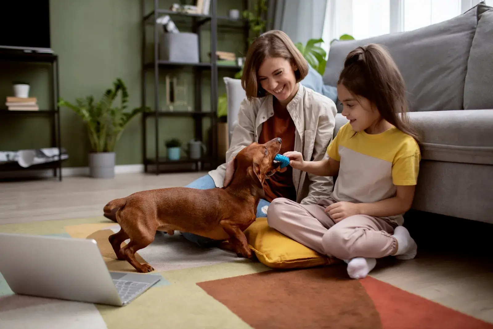 Young girl and mother playing with their dog in a clean living room, enjoying a pet-friendly home cleaned by Sparkle n’ Clean in Lake Forest.