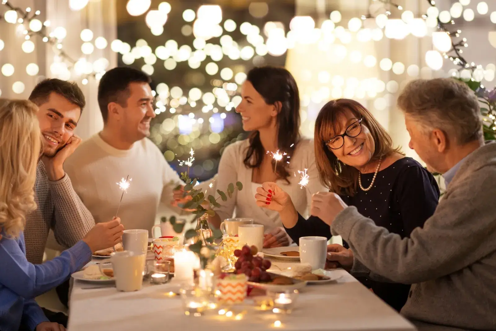 Family enjoying a warm holiday gathering in a clean, cozy home with festive lights and shared moments