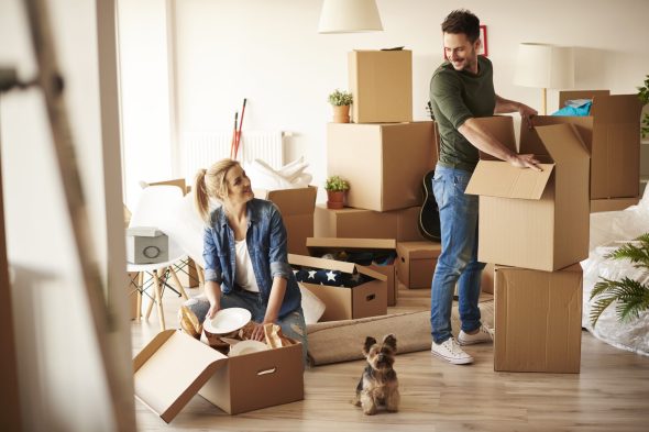 Young couple in new apartment with small dog Happy dog in a clean, pet-friendly home cleaned by Sparkle n' Clean in Orange County